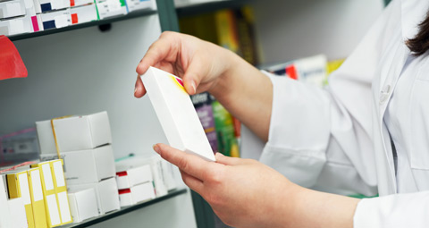 Pharmacist holding box of medication